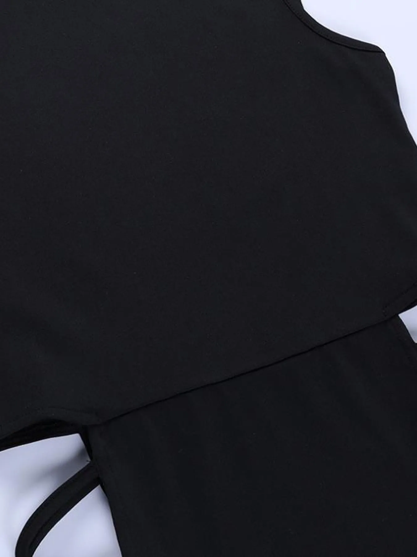 Sleeveless bodycon dress with hollow out sides and double high slit black party dress closeup fabric