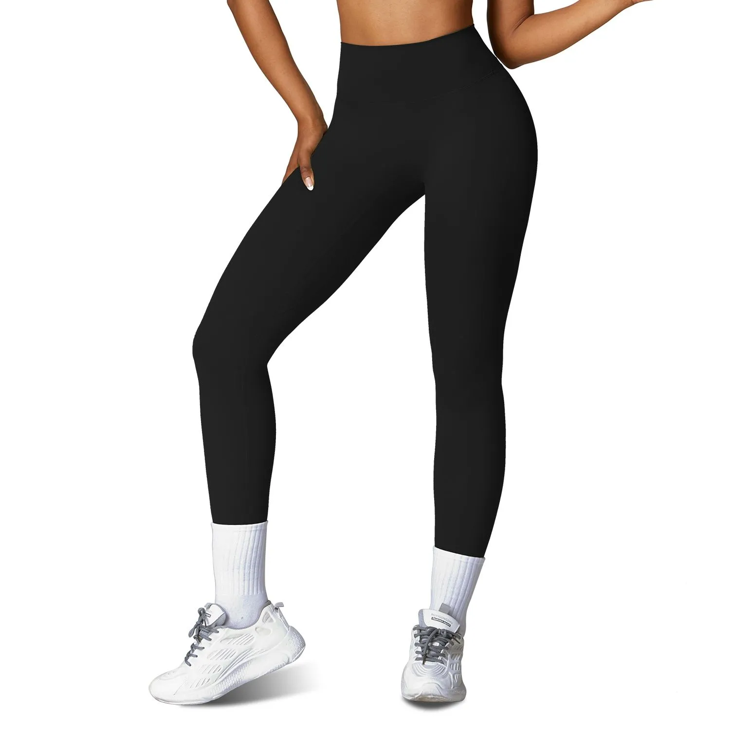 Woman wearing black high waisted yoga leggings with compression support