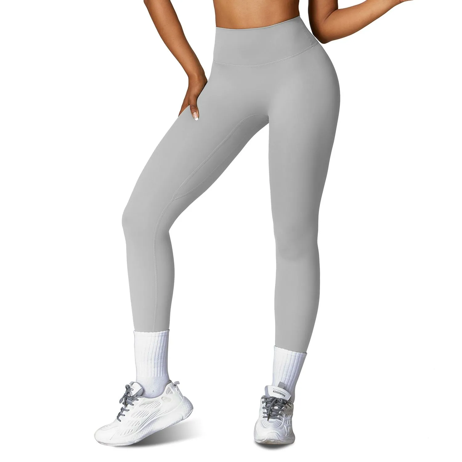 Woman wearing grey high waisted compression workout leggings for yoga and fitness