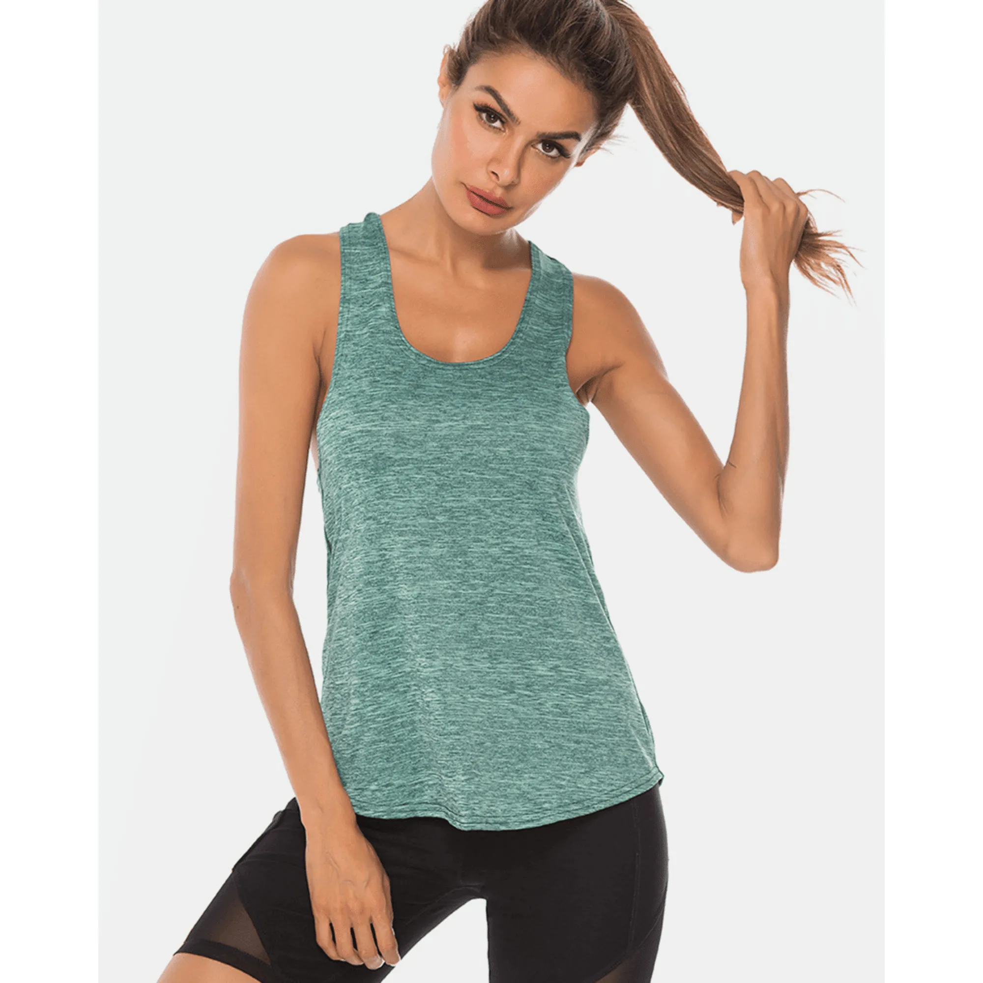 Model wearing a teal scoop-neck workout tank top while holding her ponytail.
