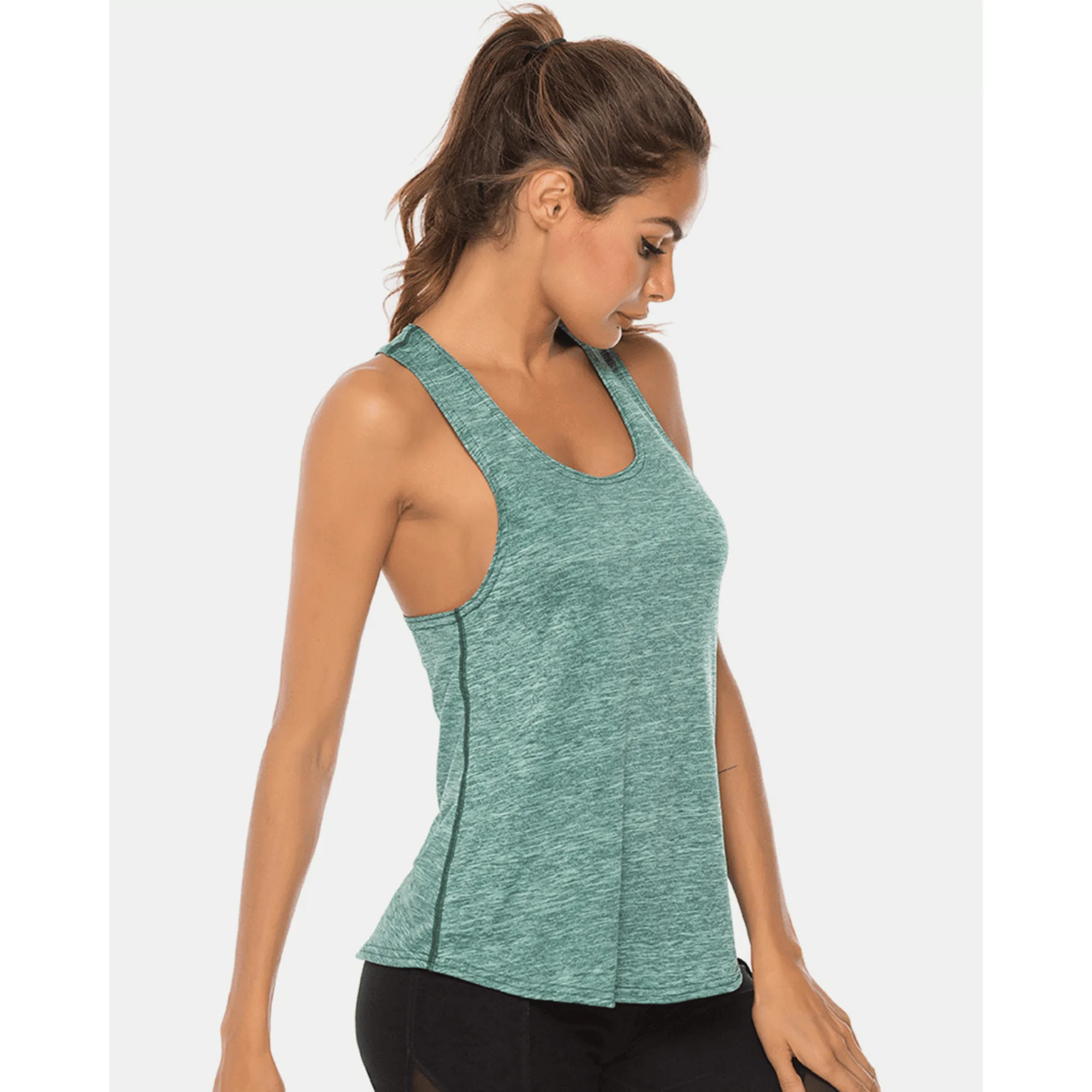 Side view of a model wearing a teal long scoop-neck workout tank top.