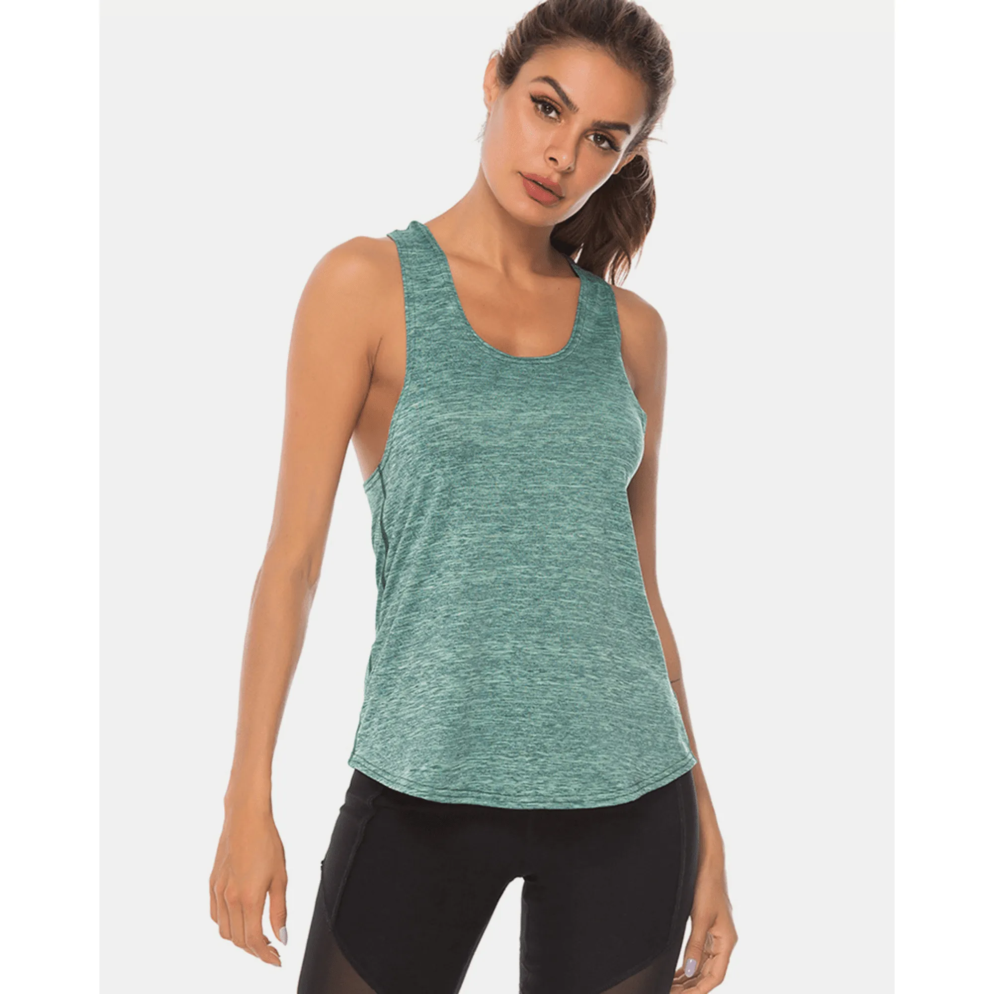 Model wearing a teal long scoop-neck workout tank top from the front.