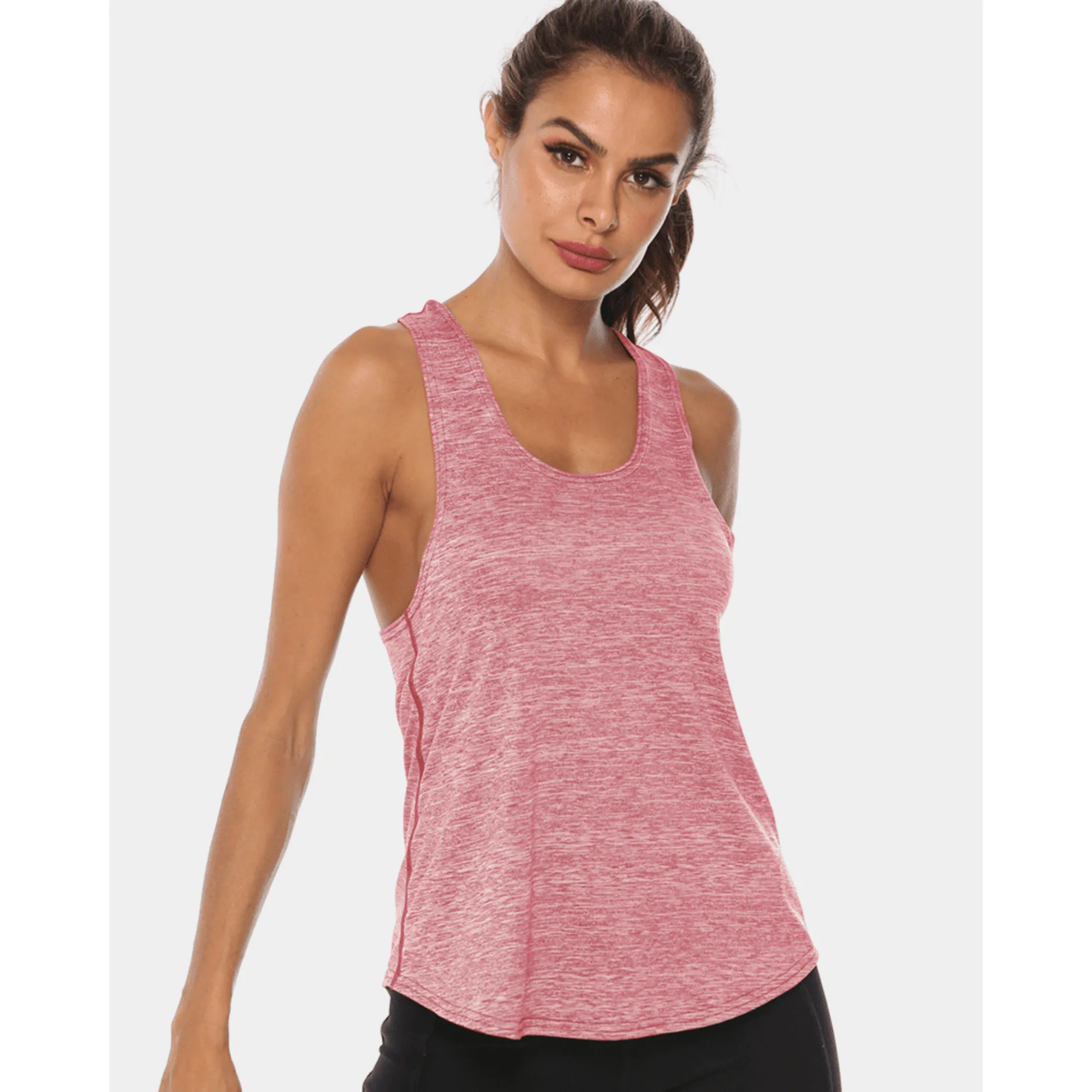 Model wearing a rose-pink long scoop-neck workout tank top in a front angled pose.
