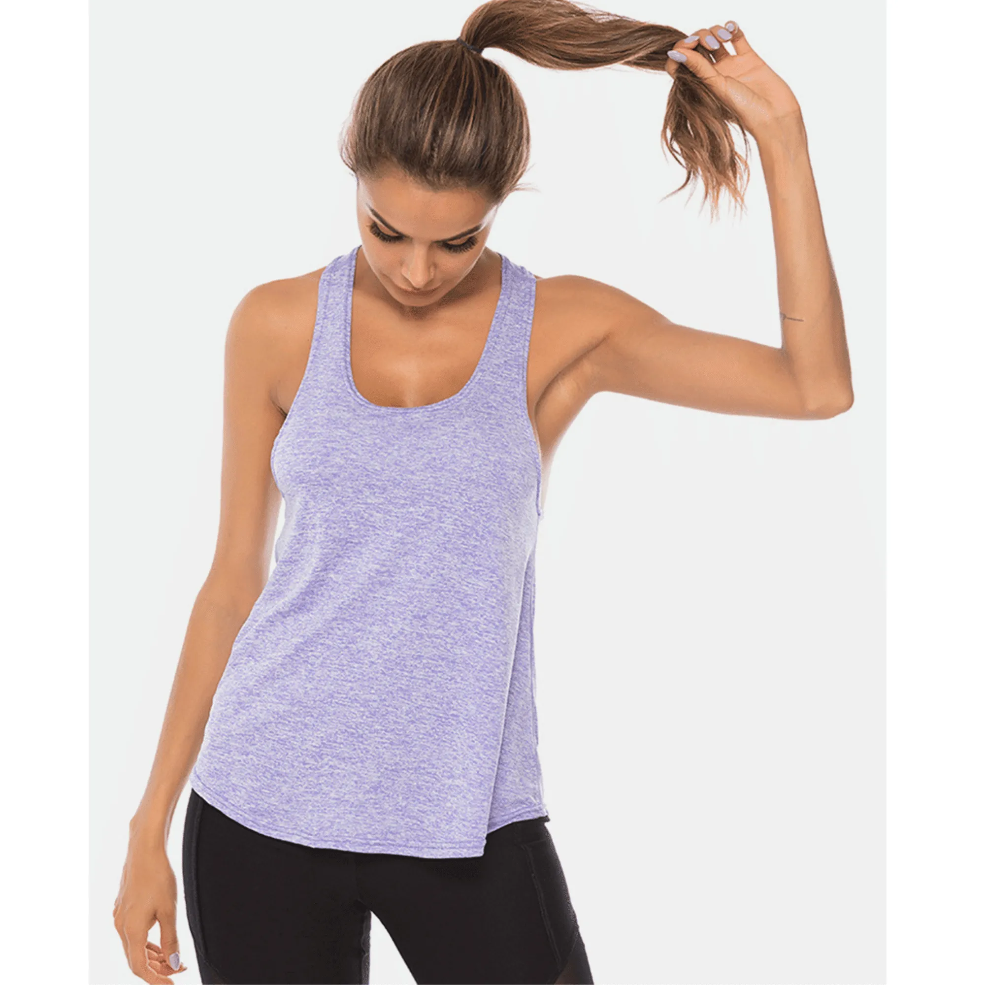 Model looking down while wearing a lavender long scoop-neck workout tank top.