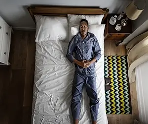 Man Sleeping Alone On The Bed
