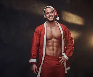 Young Sexy Santa In His Pajamas Posing